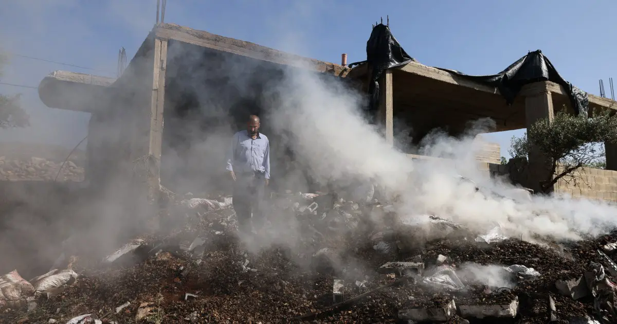 A Palestinian is killed as Israeli settlers storm his village and troops fire on stone-throwers