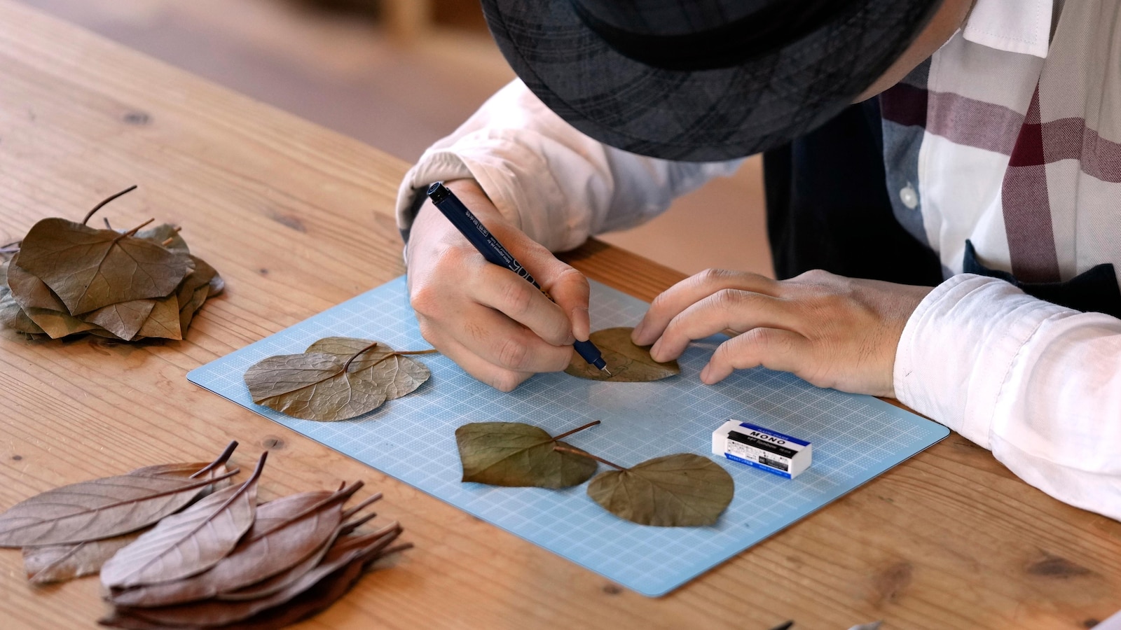 AP PHOTOS: A Japanese artist finds solace and global fans with intricate leaf-cutting